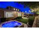 Inviting backyard with a jacuzzi, patio, pergola, string lights, and well-manicured landscaping perfect for relaxation at 5741 Shadow Bend Dr, Las Vegas, NV 89135