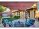 Relaxing backyard space with a covered patio, comfortable seating, and a hot tub for ultimate leisure at 5741 Shadow Bend Dr, Las Vegas, NV 89135