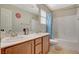 Bright bathroom featuring double sinks, updated fixtures, and a shower-tub combination at 5741 Shadow Bend Dr, Las Vegas, NV 89135