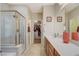 Bathroom with a shower, long vanity with double sinks, and an entrance to the walk-in closet at 5741 Shadow Bend Dr, Las Vegas, NV 89135
