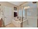 Modern bathroom with a glass shower, a soaking tub with a faucet, a large mirror and a white door at 5741 Shadow Bend Dr, Las Vegas, NV 89135