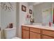 Well-lit bathroom featuring a vanity with wood cabinets and decorative accents at 5741 Shadow Bend Dr, Las Vegas, NV 89135