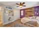 Charming bedroom with unique wood accent wall, ceiling fan, and window at 5741 Shadow Bend Dr, Las Vegas, NV 89135