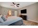 Spacious bedroom with wood-look flooring, ceiling fan, and ample natural light at 5741 Shadow Bend Dr, Las Vegas, NV 89135