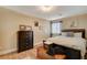 Cozy bedroom with dark wood furniture, soft bedding, and ample natural light at 5741 Shadow Bend Dr, Las Vegas, NV 89135