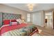 Comfortable bedroom featuring a king-size bed, soft carpet, and a decorative light fixture at 5741 Shadow Bend Dr, Las Vegas, NV 89135