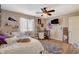 Comfortable bedroom featuring a desk, ceiling fan, and window for natural light at 5741 Shadow Bend Dr, Las Vegas, NV 89135