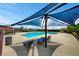 Community pool area with lounge chairs and umbrellas for relaxing by the water at 5741 Shadow Bend Dr, Las Vegas, NV 89135