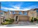 Charming two-story home with a neutral exterior, landscaped front yard, paved driveway, and a two-car garage at 5741 Shadow Bend Dr, Las Vegas, NV 89135