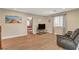 Relaxing living room with wood floors, a comfortable couch, and a view of the adjacent bedroom at 5741 Shadow Bend Dr, Las Vegas, NV 89135
