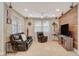 Comfortable living room with tile flooring, ceiling fan, and a feature wall with speakers for entertainment at 5741 Shadow Bend Dr, Las Vegas, NV 89135