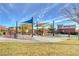Community playground featuring slides and climbing structures shaded by colorful awnings for sun protection at 5741 Shadow Bend Dr, Las Vegas, NV 89135