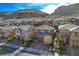 Residential street showcasing well-kept homes with desert landscaping, against a backdrop of scenic mountains at 5741 Shadow Bend Dr, Las Vegas, NV 89135