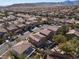 Aerial view of homes featuring manicured yards, swimming pools, and mountain views at 575 Lacabana Beach Dr, Las Vegas, NV 89138
