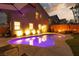 Lush backyard featuring a private pool, modern lighting, and a comfortable lounge area at 575 Lacabana Beach Dr, Las Vegas, NV 89138