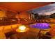 Inviting backyard pool at dusk with a cozy fire pit and comfortable seating area at 575 Lacabana Beach Dr, Las Vegas, NV 89138