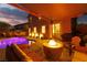 Backyard with a fire pit, patio furniture, and a shimmering pool, ideal for entertaining at 575 Lacabana Beach Dr, Las Vegas, NV 89138