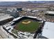 Aerial view of the baseball field with seating and a lush green playing surface, set against a mountain backdrop at 575 Lacabana Beach Dr, Las Vegas, NV 89138