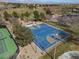 Overhead view of a well-maintained basketball court, adjacent to tennis courts, surrounded by greenery at 575 Lacabana Beach Dr, Las Vegas, NV 89138
