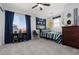 Bright bedroom featuring blue curtains, sports decor, and a cozy striped bedding set at 575 Lacabana Beach Dr, Las Vegas, NV 89138