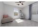 Bedroom featuring neutral paint, carpet, chair, and light from two windows at 575 Lacabana Beach Dr, Las Vegas, NV 89138
