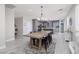 Open concept dining room features a decorative chandelier and neutral color palette at 575 Lacabana Beach Dr, Las Vegas, NV 89138
