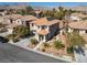 Inviting two-story home featuring desert landscaping, a tile roof and mountain views at 575 Lacabana Beach Dr, Las Vegas, NV 89138