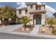 Beautiful two-story home with a manicured front yard, a covered porch, and a welcoming curb appeal at 575 Lacabana Beach Dr, Las Vegas, NV 89138