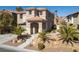 Charming two-story home with a well-manicured front yard and a welcoming entrance at 575 Lacabana Beach Dr, Las Vegas, NV 89138