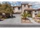Inviting two-story home with attached garage, covered entryway, and well-maintained yard at 575 Lacabana Beach Dr, Las Vegas, NV 89138