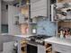 Well-organized kitchen with pull out drawers, stainless steel appliances and blue backsplash at 575 Lacabana Beach Dr, Las Vegas, NV 89138