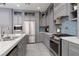 Spacious kitchen boasts stainless steel appliances, gray cabinetry, and stylish tile backsplash at 575 Lacabana Beach Dr, Las Vegas, NV 89138
