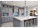 Gorgeous kitchen featuring an oversized island with seating, stainless steel appliances, and stylish backsplash at 575 Lacabana Beach Dr, Las Vegas, NV 89138