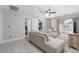 Relaxing living room with a large sofa, a ceiling fan and outside views at 575 Lacabana Beach Dr, Las Vegas, NV 89138