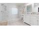 Main bathroom featuring a large shower with marble tiling and dual sink vanity at 575 Lacabana Beach Dr, Las Vegas, NV 89138