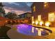 Stunning backyard featuring a sparkling pool, ample seating, and lush landscaping for ultimate relaxation at 575 Lacabana Beach Dr, Las Vegas, NV 89138