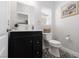 Stylish powder room featuring a black vanity and pebble tile flooring at 575 Lacabana Beach Dr, Las Vegas, NV 89138