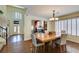 Dining room with wood floors, natural light, and views of the living room at 6686 Enchanted Cove Ct, Las Vegas, NV 89139