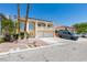 Inviting two-story home featuring a balcony, three-car garage, and desert landscaping at 6686 Enchanted Cove Ct, Las Vegas, NV 89139