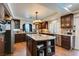 Beautiful kitchen featuring granite countertops, stainless steel appliances, and dark wood cabinetry at 6686 Enchanted Cove Ct, Las Vegas, NV 89139