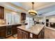 Gourmet kitchen island with granite counters, wine cooler and hardwood floors at 6686 Enchanted Cove Ct, Las Vegas, NV 89139