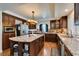 Beautiful kitchen featuring granite countertops, stainless steel appliances, and dark wood cabinetry at 6686 Enchanted Cove Ct, Las Vegas, NV 89139