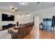 Living room with hardwood floors, ceiling fans, and lots of entertainment space at 6686 Enchanted Cove Ct, Las Vegas, NV 89139
