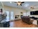 Cozy living room featuring hardwood floors, fireplace, and access to outdoor pool at 6686 Enchanted Cove Ct, Las Vegas, NV 89139