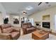 Living room with hardwood floors, ceiling fans, and a cozy fireplace at 6686 Enchanted Cove Ct, Las Vegas, NV 89139