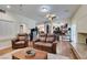 Spacious living room featuring hardwood floors, a ceiling fan, and comfortable leather furniture at 6686 Enchanted Cove Ct, Las Vegas, NV 89139