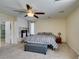 Spacious main bedroom boasting a fireplace, ceiling fan, sitting area and an ensuite bath at 6686 Enchanted Cove Ct, Las Vegas, NV 89139