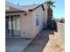 Exterior shot of the backyard featuring a shed, covered patio, and block wall at 6760 Fallona Ave, Las Vegas, NV 89156