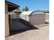 Enclosed backyard features a chain link fence, shed, and covered patio at 6760 Fallona Ave, Las Vegas, NV 89156