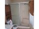 Bathroom showcasing a glass shower with a white shower base and a wooden storage cabinet at 6760 Fallona Ave, Las Vegas, NV 89156